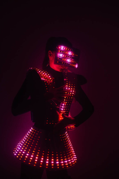 Sexy disco dancer dancing in a UV suit to music. Parties and dances. - Foto, Imagen