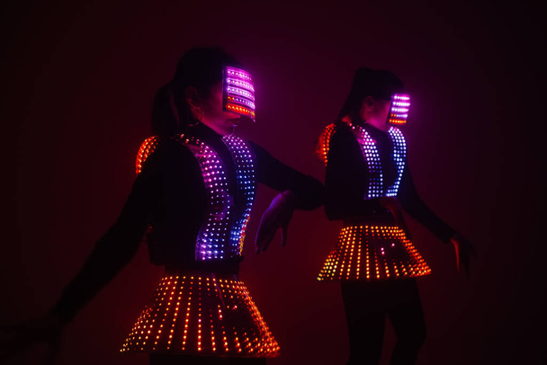 Two sexy disco dancers move in UV costumes. Parties and dances. - Foto, Imagen