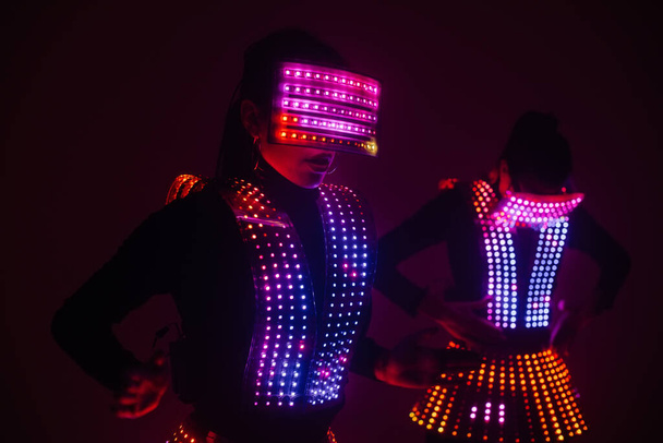 Two sexy disco dancers move in UV costumes. Parties and dances. - Fotó, kép