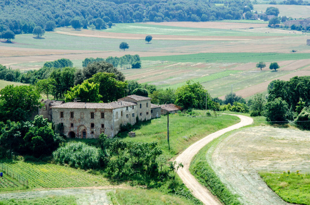 Old building against green field and trees, Tuscany Italy - Fotoğraf, Görsel