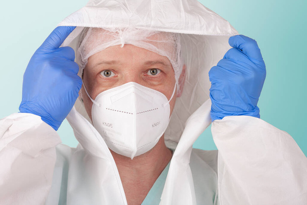 男性看護師顔マスクffp2ドレスアップ保護カバー服。病院のICUでウイルスに対して保護するための個人用保護具. - 写真・画像