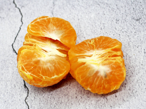 Orange mandarin or tangerine fruit, grey background, food - Photo, Image