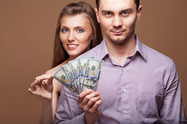 Loving couple are holding a large sum of money. Business concept - Φωτογραφία, εικόνα