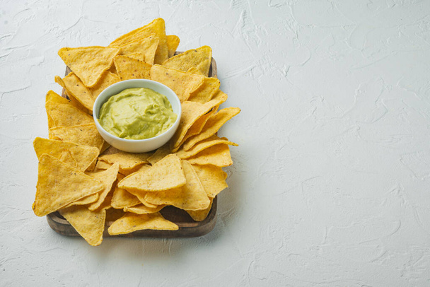 Corn tortilla chips nachos and dip sauce, on white background with copy space for text - Фото, зображення