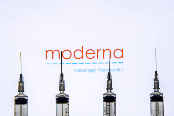 Kathmandu, Nepal - January 03 2021: Closeup of a syringe against Moderna logo - Foto, Imagen