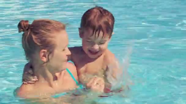 Mãe e seu filho na piscina exterior
 - Filmagem, Vídeo
