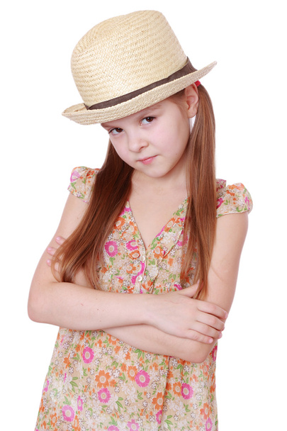 Little girl in summer dress and straw hat - Fotó, kép