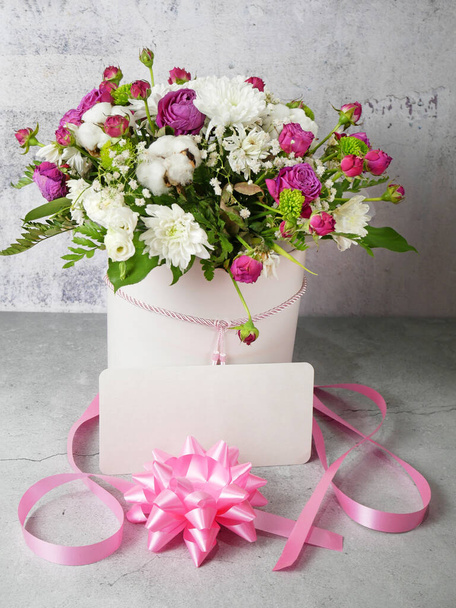 huge bouquet with asters and roses with ribbon, bow, and empty blank - Photo, Image
