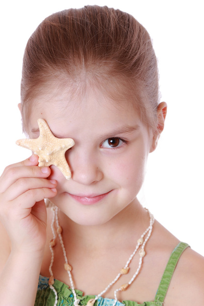 Little girl holds little star fish - 写真・画像