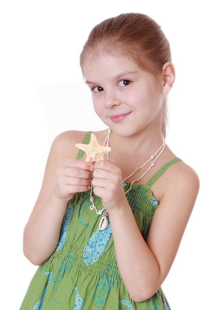Little girl holds little star fish - Фото, зображення