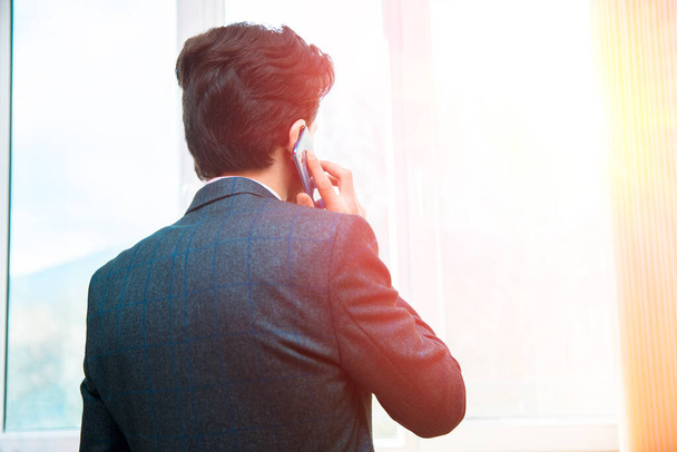 man talking in phone in window backgroun - Photo, Image
