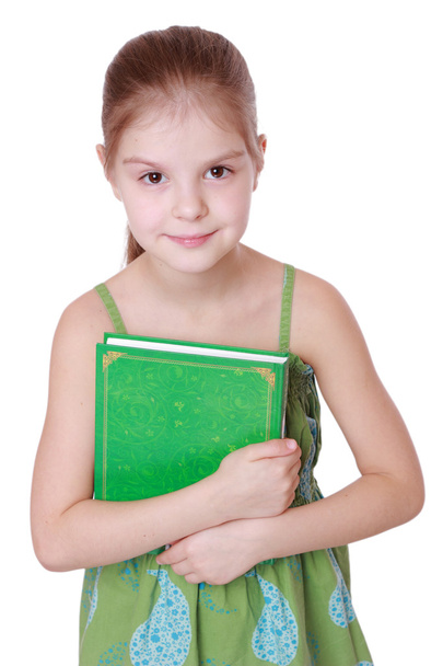 Little girl with green book - Foto, imagen