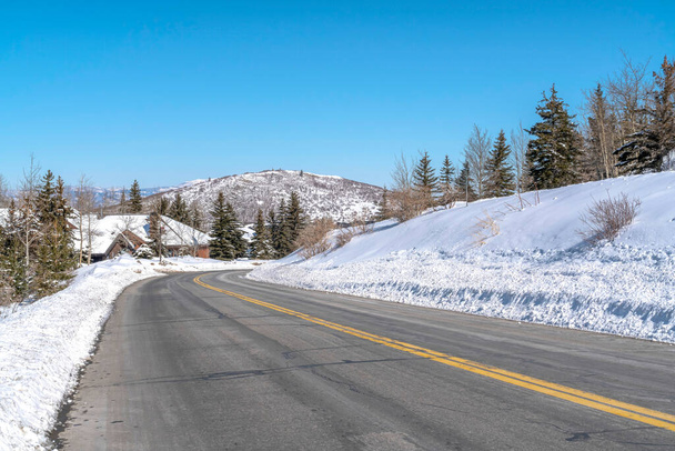 Park City landscape with paved mountain road on a scenic snowy scene in winter - Photo, Image