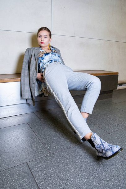 European girl in blue suit sitting in the metro - Photo, Image