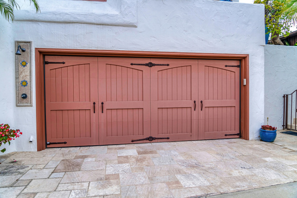 Two car garage with hinged wood doors against white wall in San Diego California - Photo, Image