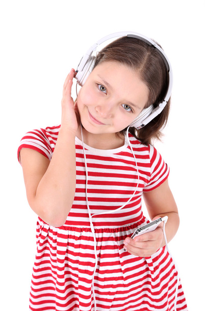 Beautiful little girl listening to music, isolated on white - Photo, image