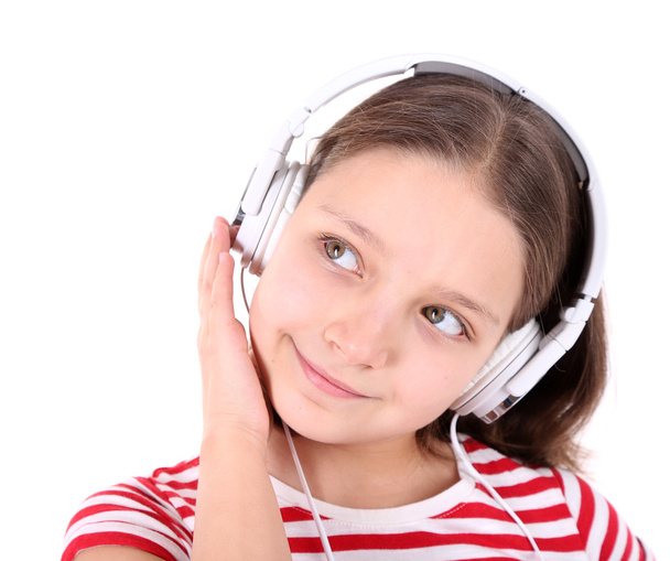 Beautiful little girl listening to music, isolated on white - Foto, Imagen