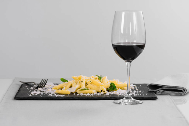 pasta with grated cheese and herbs on a slate tray - Photo, Image