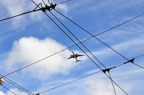 Photo of a jet liner intertwined with electrical  wires - Photo, Image