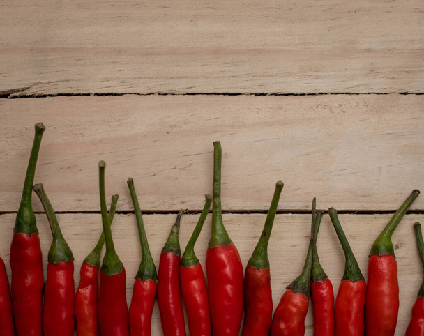 Hot and spicy red chilli on wood table background - Fotó, kép