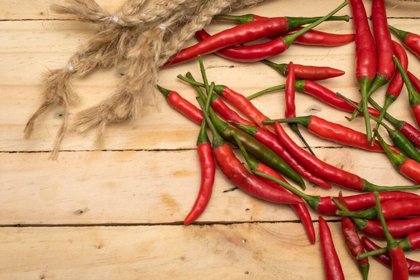Red Hot Chili Peppers over wooden background. - Photo, image
