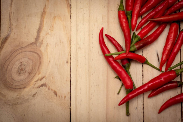 Red Hot Chili Peppers over wooden background. - Fotó, kép