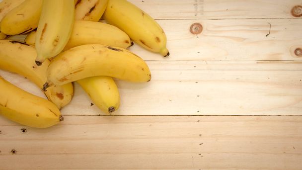 Bananas on  wooden board, top view - Photo, Image