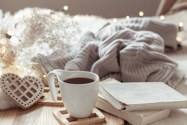 Cozy composition with a cup of coffee on a saucer and home decor details. - Photo, Image