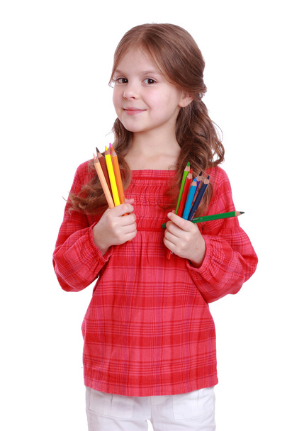 First grader holding colorful pencils - Valokuva, kuva
