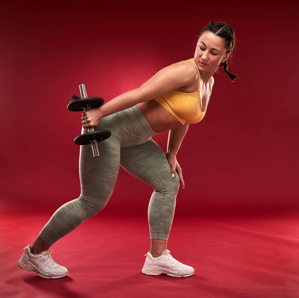 Confident plus size young woman in fitness attire exercising at studio  - Φωτογραφία, εικόνα