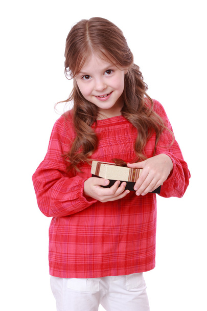 Smiling girl holding present - Photo, image