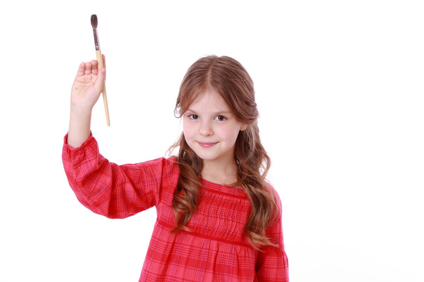 Girl holding a painting brush - Fotó, kép