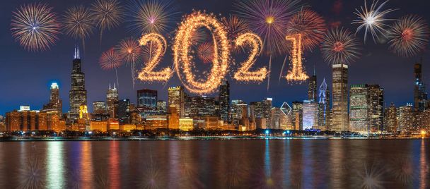2021 written with Sparkle firework with multicolor of fireworks on Panorama scene of Chicago cityscape river side along Lake Michigan background, USA skyline,Happy new year and merry Christmas concept - Photo, Image