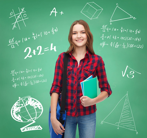 Smiling female student with bag and notebooks - Φωτογραφία, εικόνα