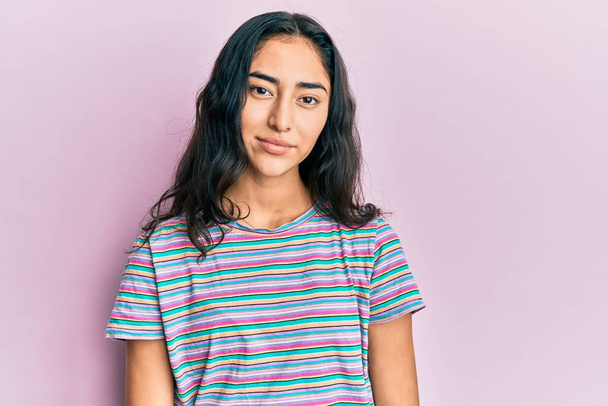 Spanyol tinédzser lány fogszabályzóval alkalmi ruhát visel lazán, komoly arckifejezéssel. egyszerű és természetes nézi a kamerát.  - Fotó, kép