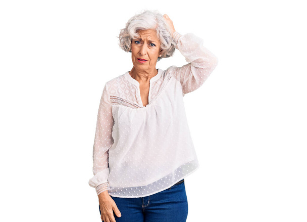 Senior grey-haired woman wearing casual clothes confuse and wonder about question. uncertain with doubt, thinking with hand on head. pensive concept.  - Foto, Bild