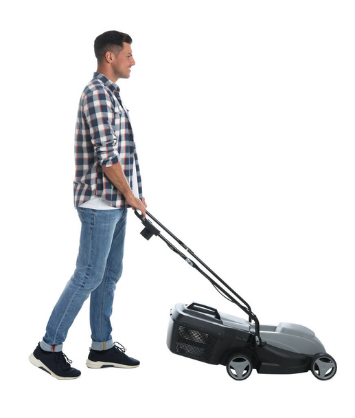 Man with modern lawn mower on white background - Zdjęcie, obraz