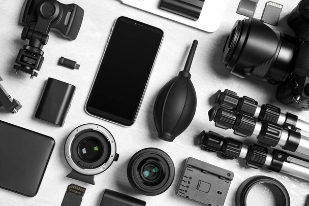 Flat lay composition with camera and video production equipment on light background - Fotografie, Obrázek