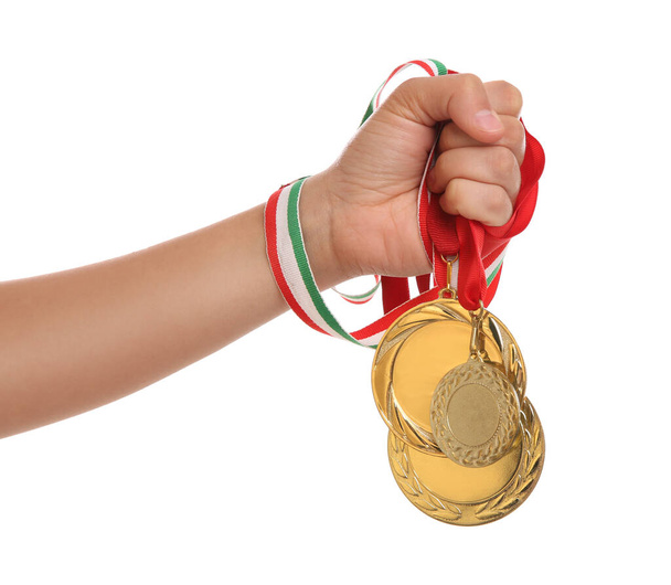 Woman holding gold medals on white background, closeup - Fotoğraf, Görsel