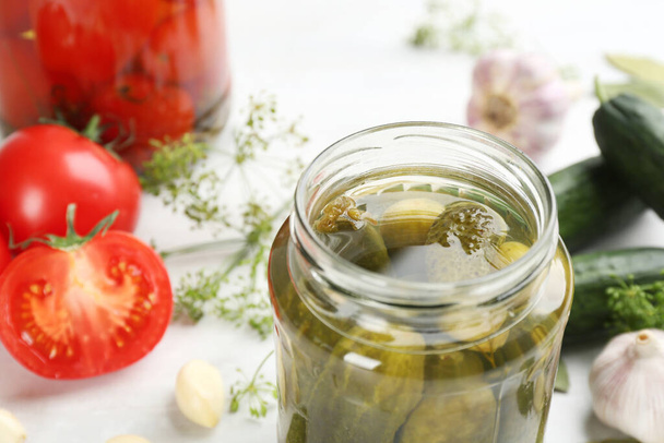 Glass jar of pickled cucumbers on table, closeup. Space for text - Foto, Imagen