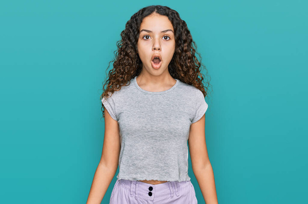 Adolescente hispana chica usando ropa casual asustada y sorprendida con la boca abierta para sorpresa, cara de incredulidad  - Foto, Imagen