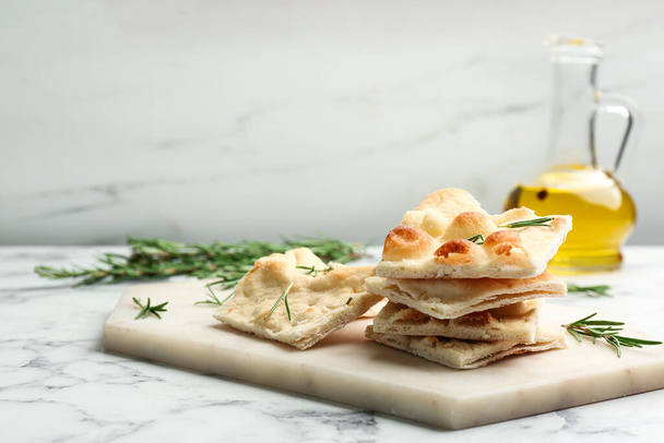 Delicious focaccia bread on white marble table - Foto, Imagen