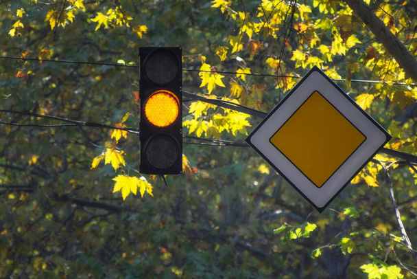 Traffic light with yellow color on sunny background. The main road. - Photo, Image