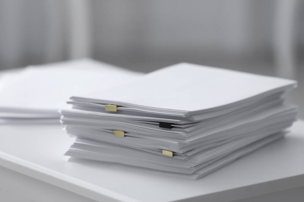 Stack of blank paper on white table - Fotoğraf, Görsel