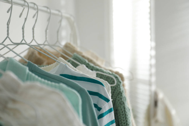 Rack with stylish women's clothes indoors, space for text. Interior design - Photo, Image