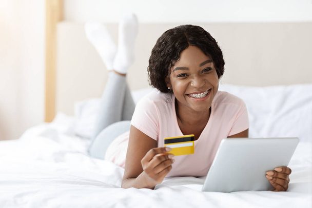 Relajada mujer negra con tarjeta de crédito y tableta digital - Foto, imagen