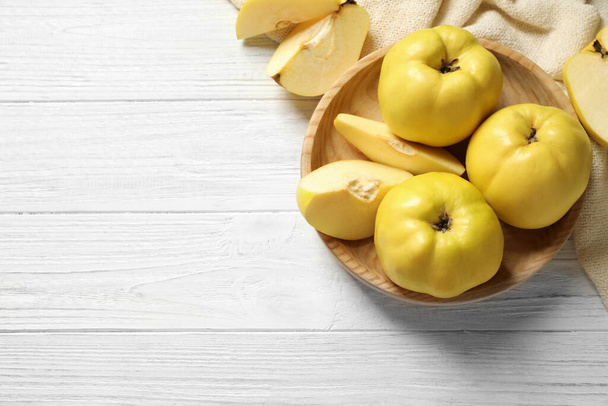 Fresh ripe organic quinces on white wooden table, flat lay. Space for text - Foto, immagini