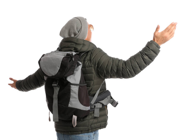 Man with backpack on white background, back view. Winter travel - Fotografie, Obrázek