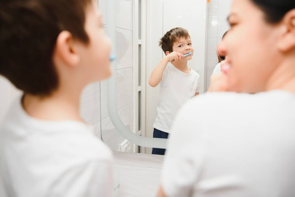 Mother washing little son in bathroom - Photo, image