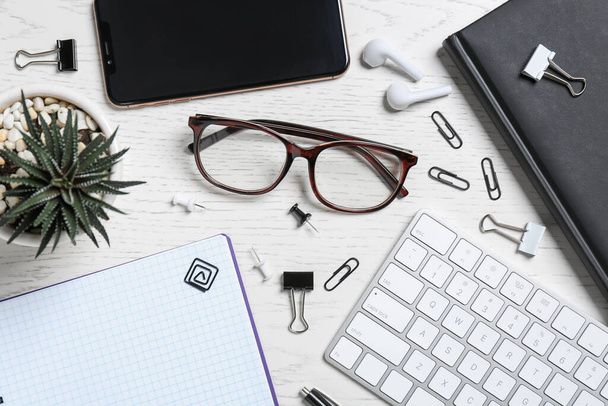 Flat lay composition with office items and glasses on wooden table - Фото, изображение